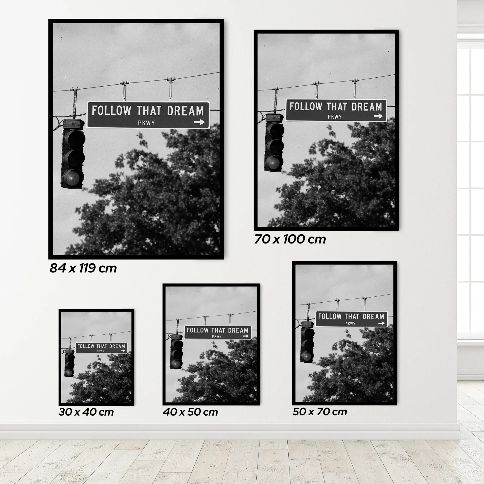 Set of framed prints with street signs and 'Follow That Dream' text, displayed on a wall.