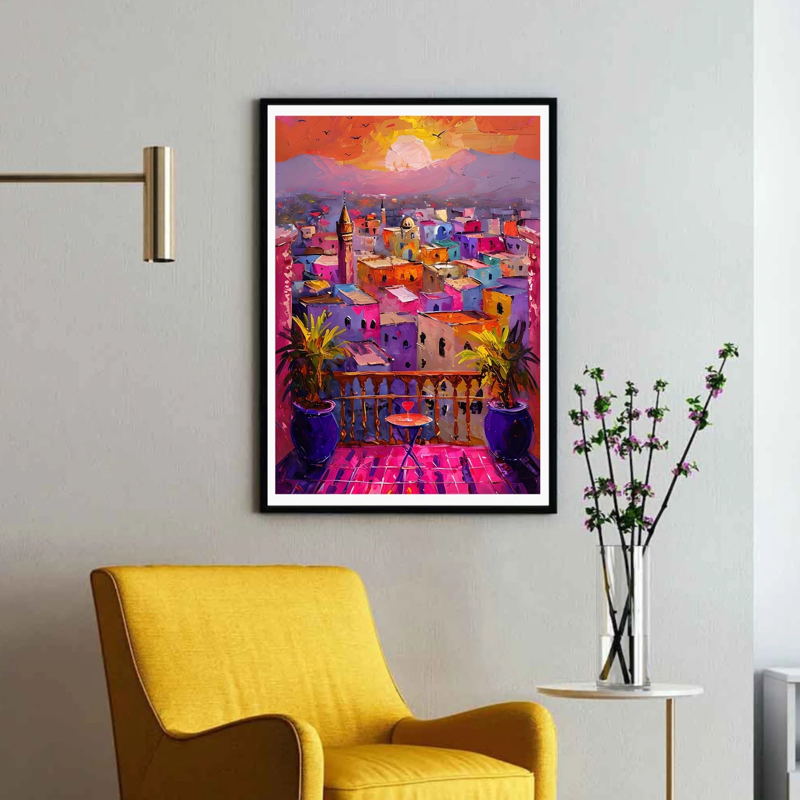 Colorful Moroccan cityscape painting on a wall above a yellow armchair.