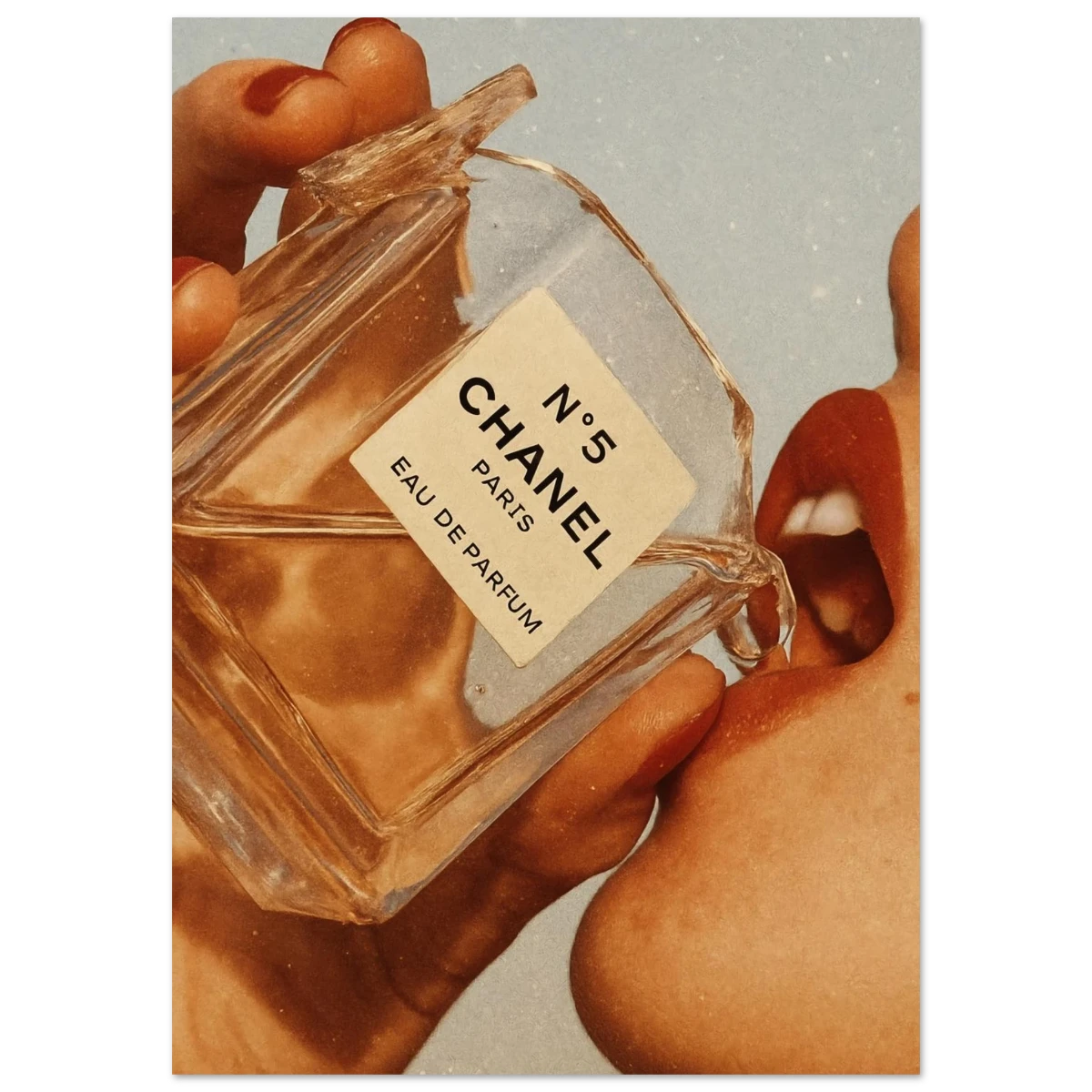 Poster of Chanel No. 5 perfume bottle held by a hand with a soft focus background