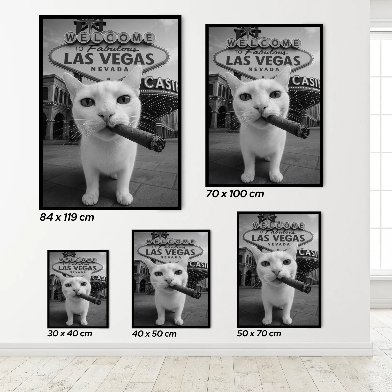 Set of framed pictures featuring a cat with a cigar in front of a Las Vegas sign, displayed on a wall.