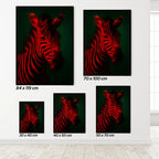 Set of zebra wall art prints in various sizes on a white wall.