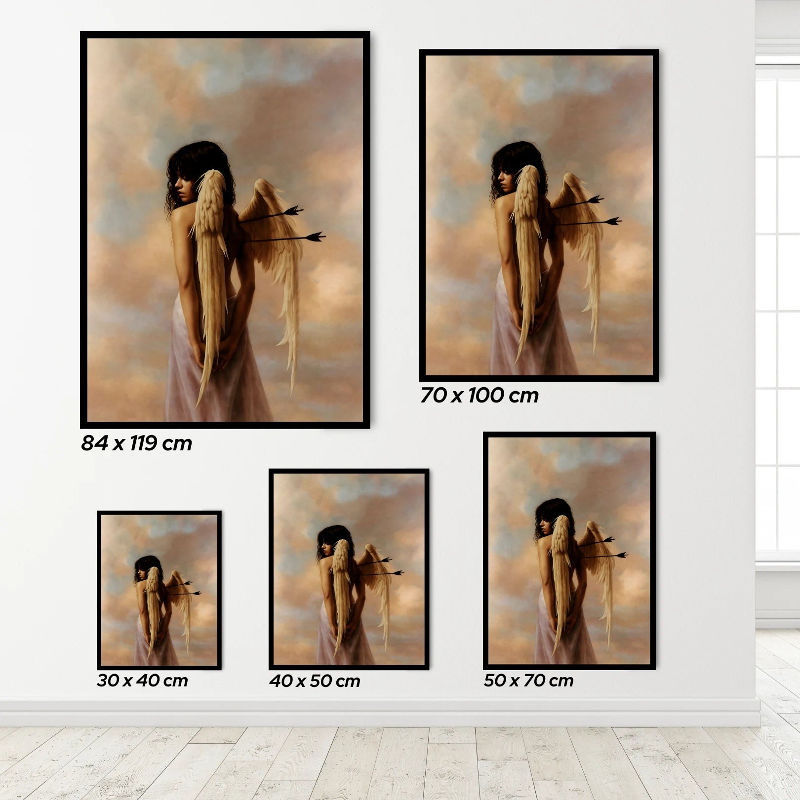 Set of framed angel art prints with different sizes on a white wall.