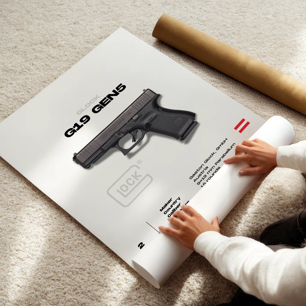 Person unrolling a poster of a glock gun on a carpeted floor