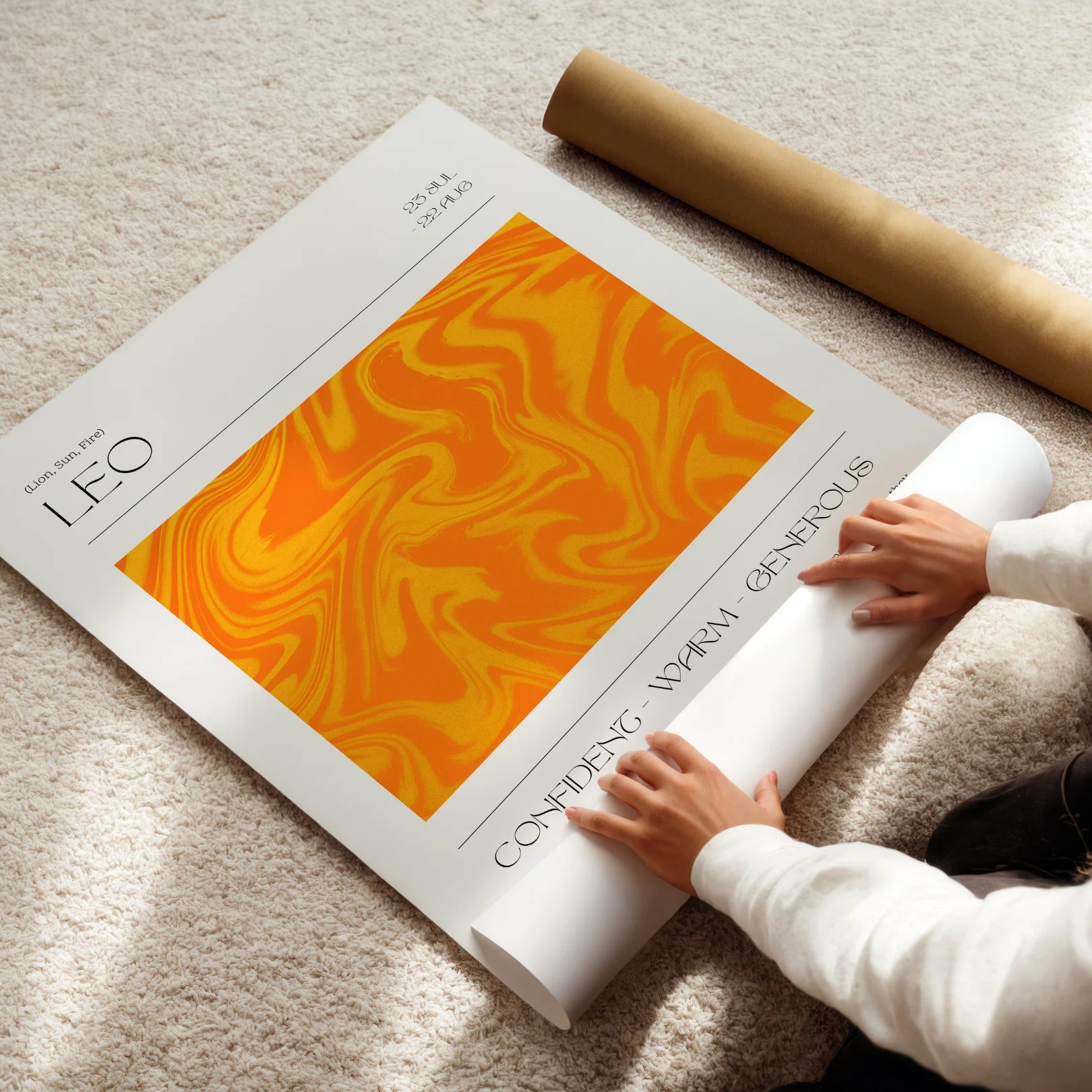 Person unrolling a large Leo zodiac poster with an orange and yellow design on a beige carpet.
