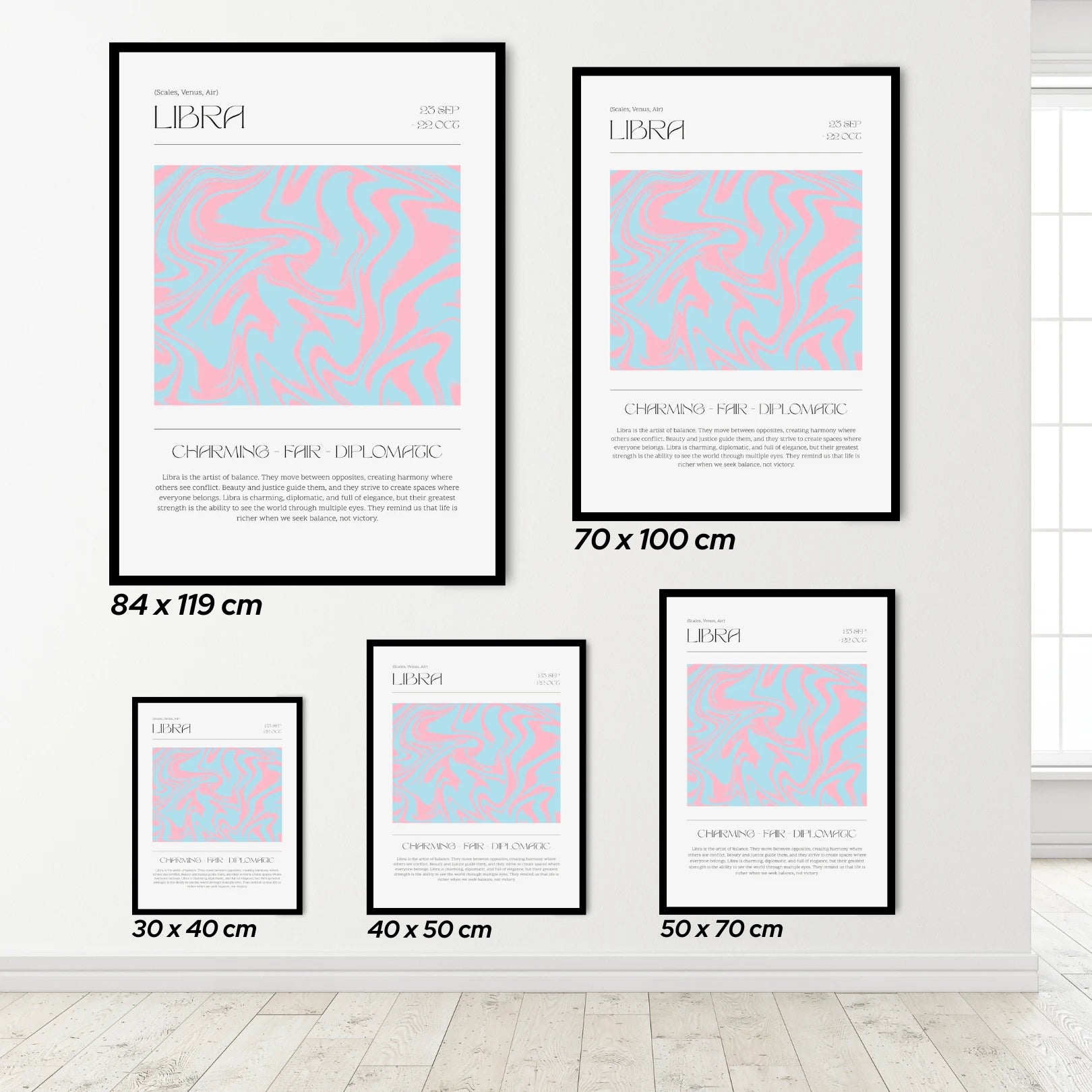 Set of framed posters with Libra zodiac design on a white wall.