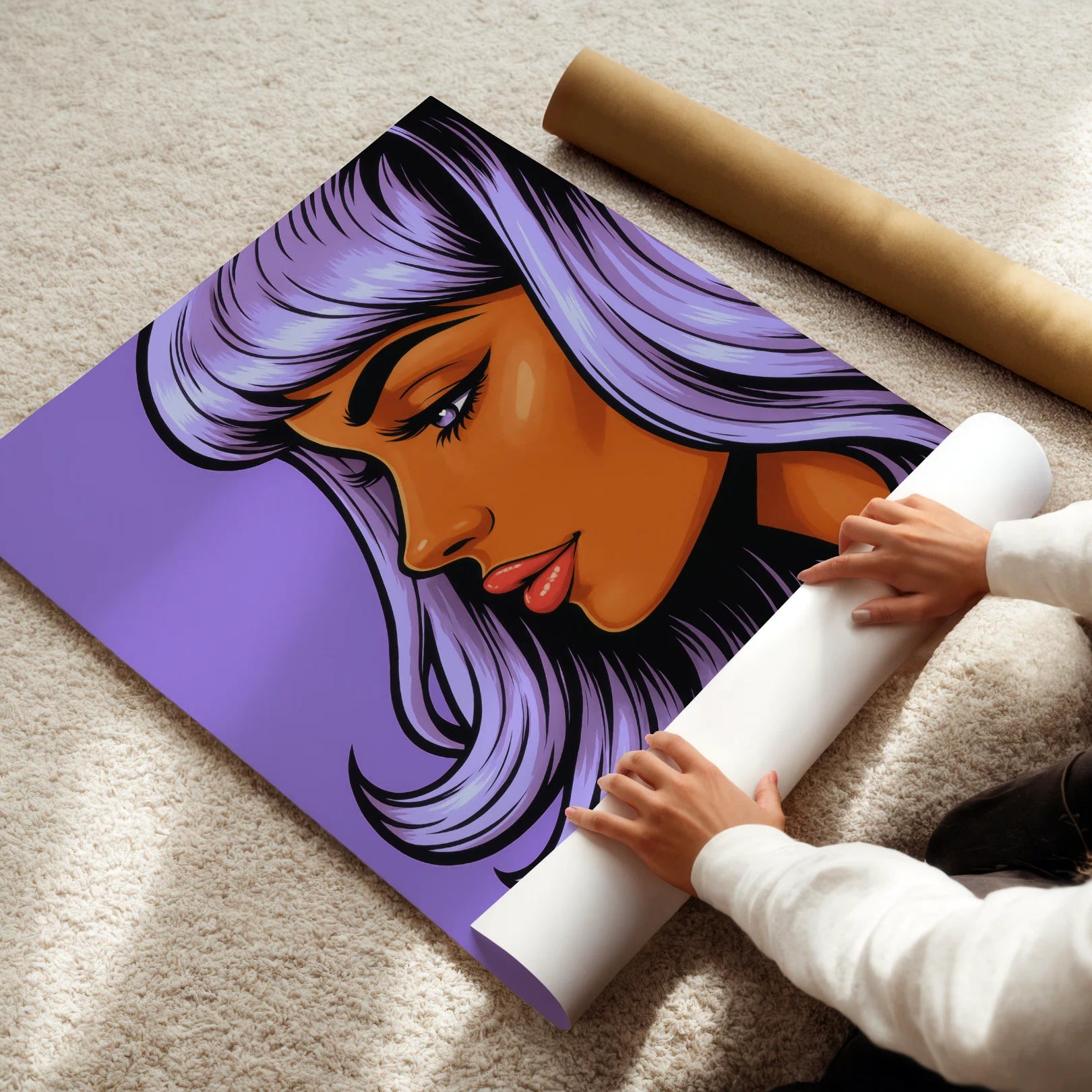 Person unrolling a poster with a stylized illustration of a woman's face on a carpeted floor.