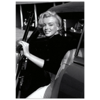 Black and white photo of Marilyn Monroe sitting in a car