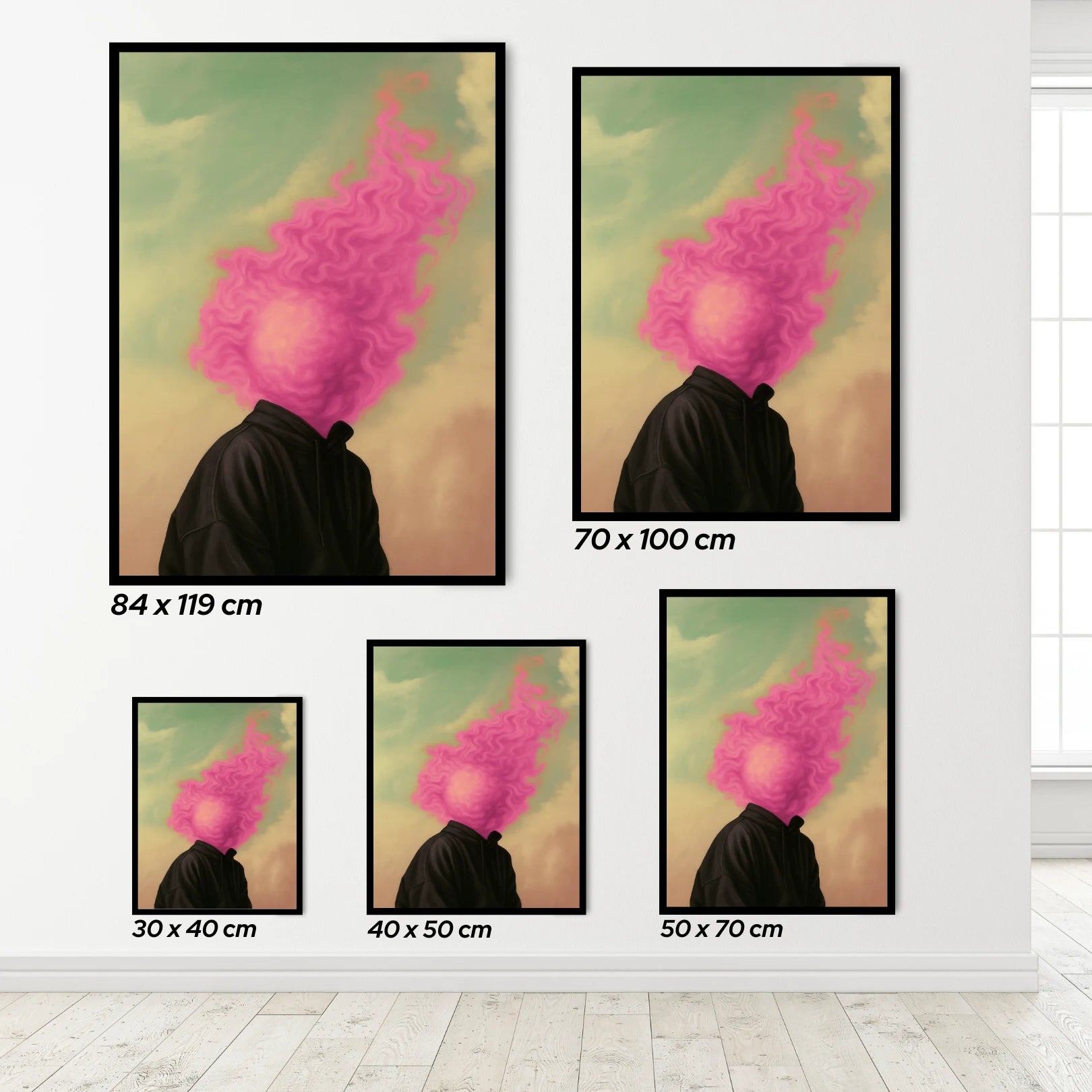 Set of framed artworks with a person with pink burning head flames on a white wall.