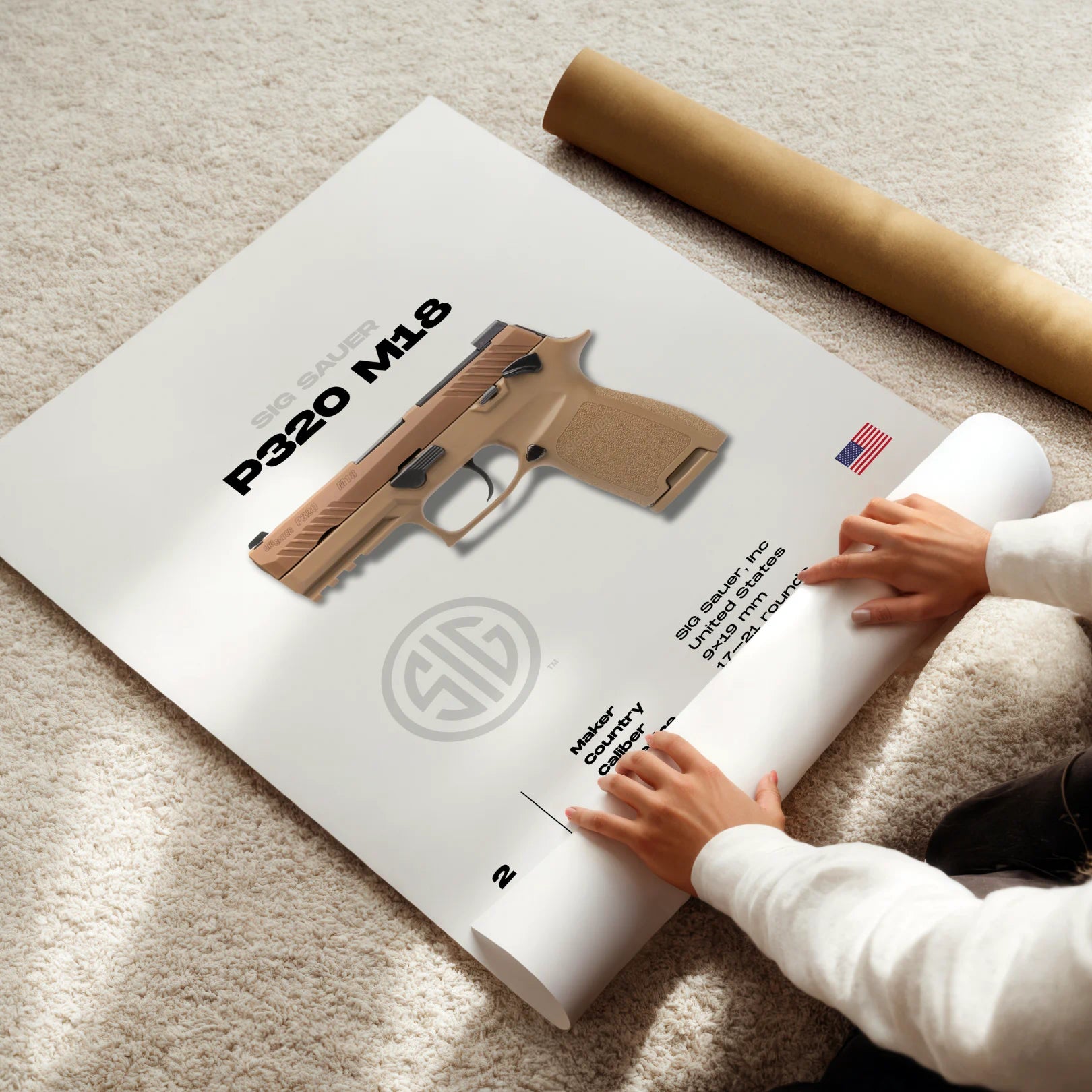 Person unrolling a poster of a sig sauer gun model on a carpeted floor