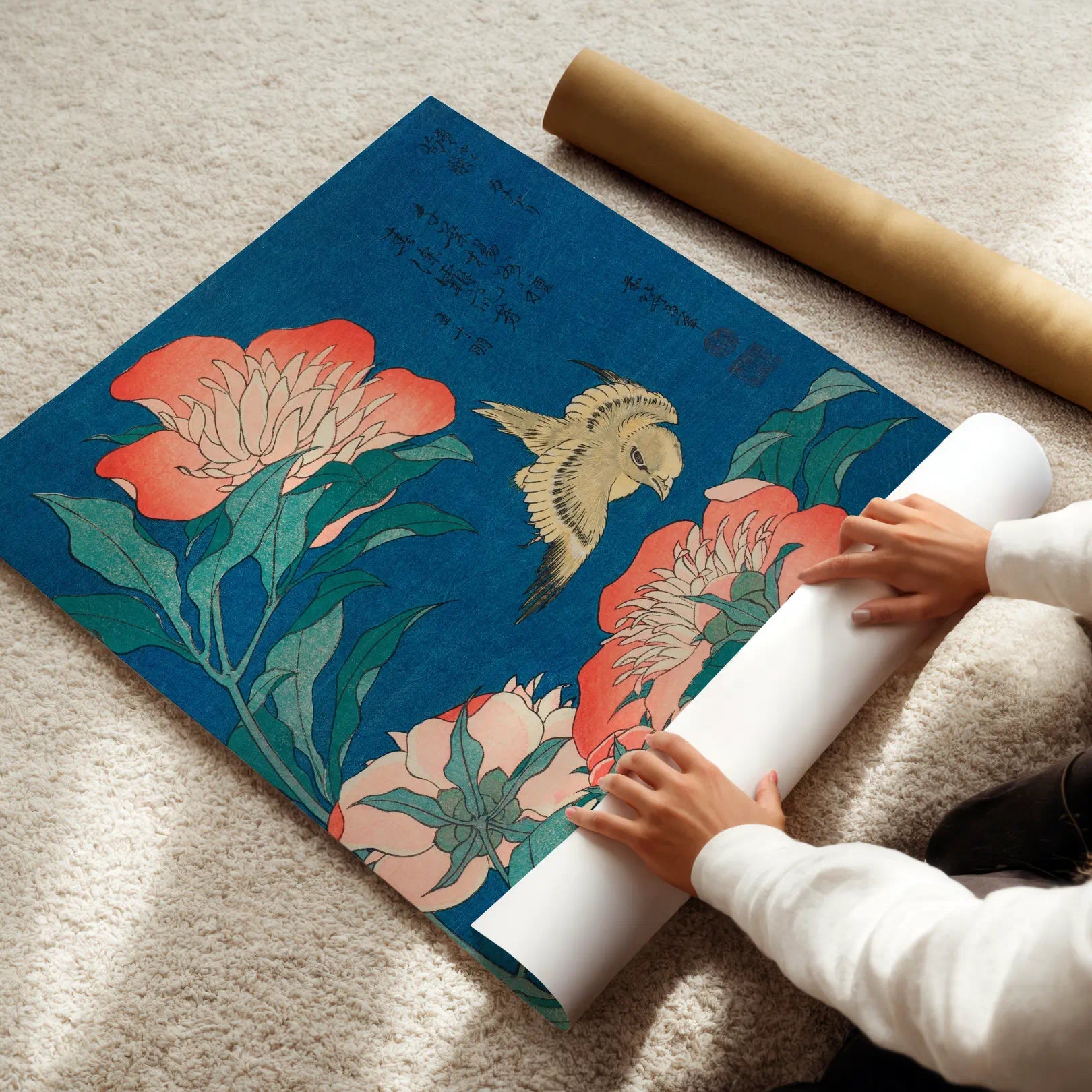 Person unrolling a large floral and fish design mat on a carpeted floor.