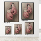 Framed prints of pink boxing gloves with 'Everlast' branding on a white wall.