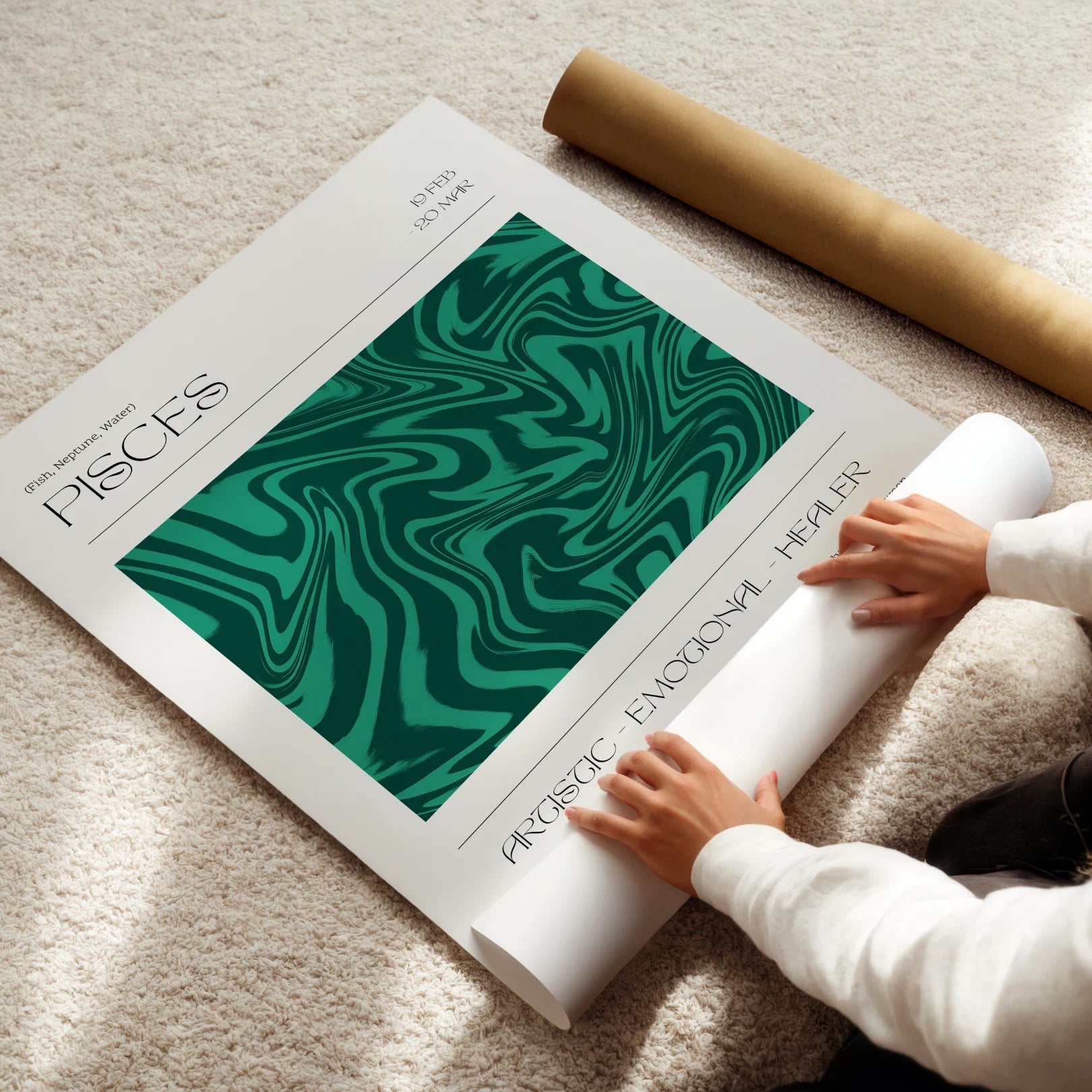 Person unrolling a large pisces zodiac poster with green abstract design on a beige carpet