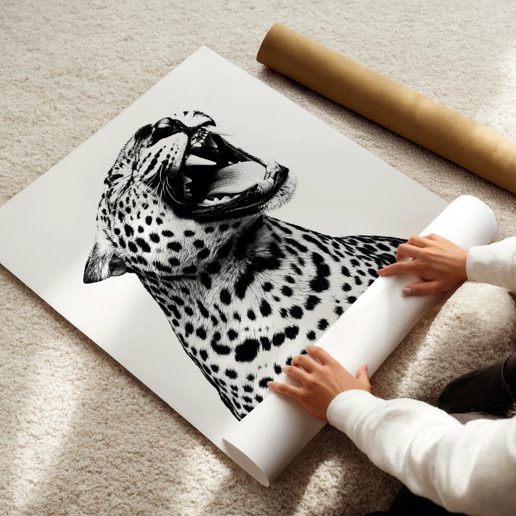 Person unrolling a large black and white leopard print poster on a light-colored floor.