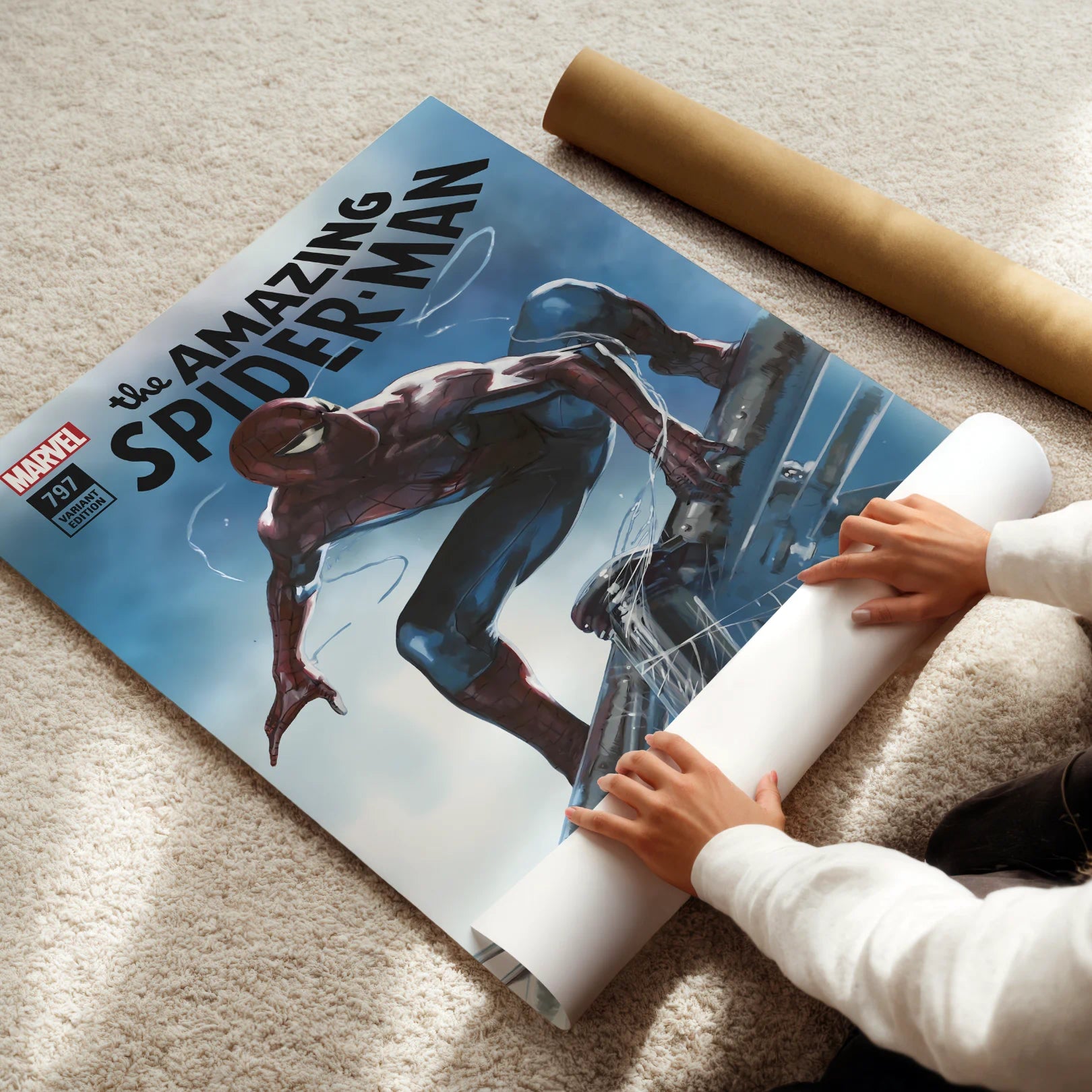 Person unrolling a large 'The Amazing Spider-Man' poster on a carpeted floor.