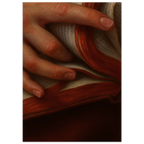 Close-up of a hand holding an open book with red pages.