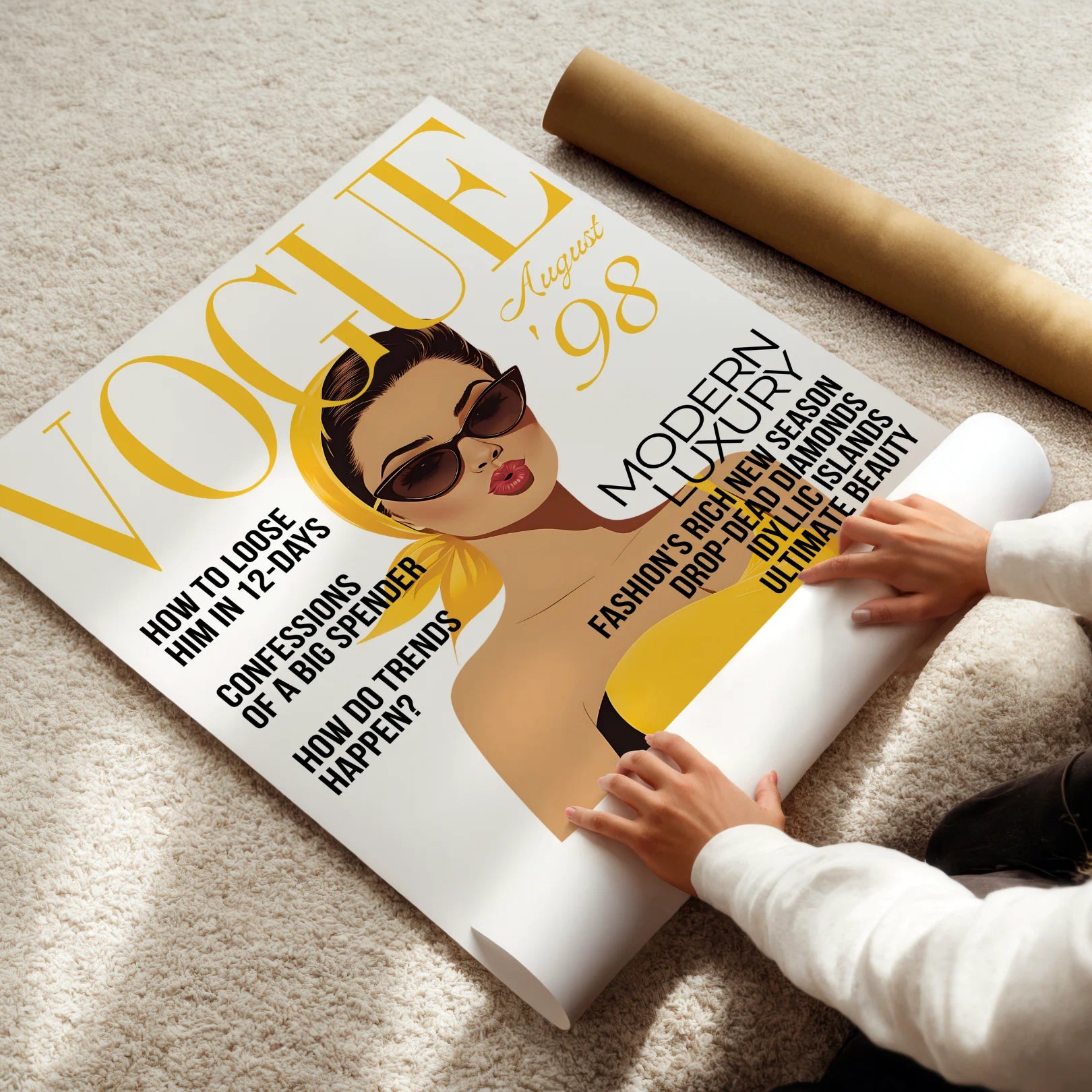 Person unrolling a large magazine cover poster featuring a woman with sunglasses and text.