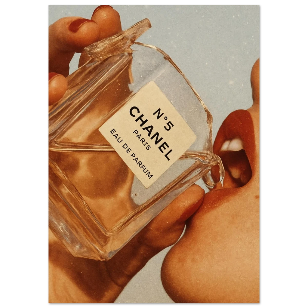 Poster of Chanel No. 5 perfume bottle held by a hand with a soft focus background