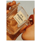 Poster of Chanel No. 5 perfume bottle held by a hand with a soft focus background